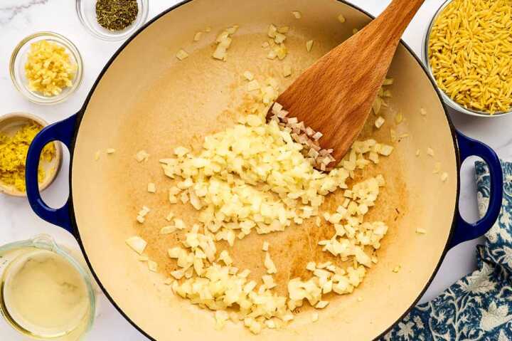 Sautéing onion in a pan.