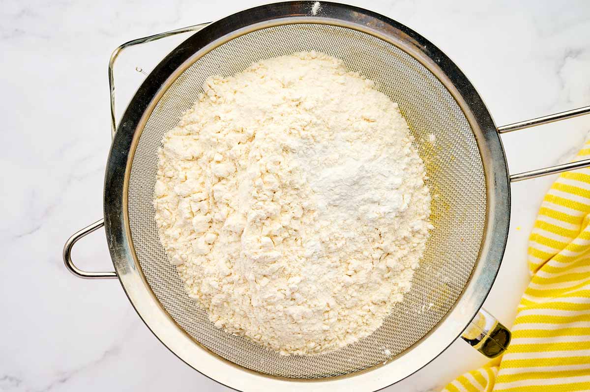 Sifting flour and baking powder.