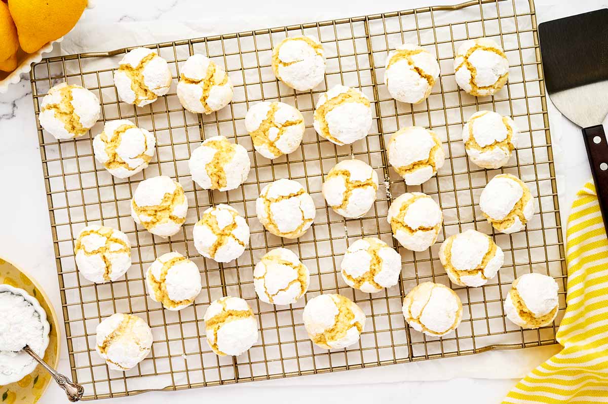 Lemon crinkle cookies on a cooling rack.