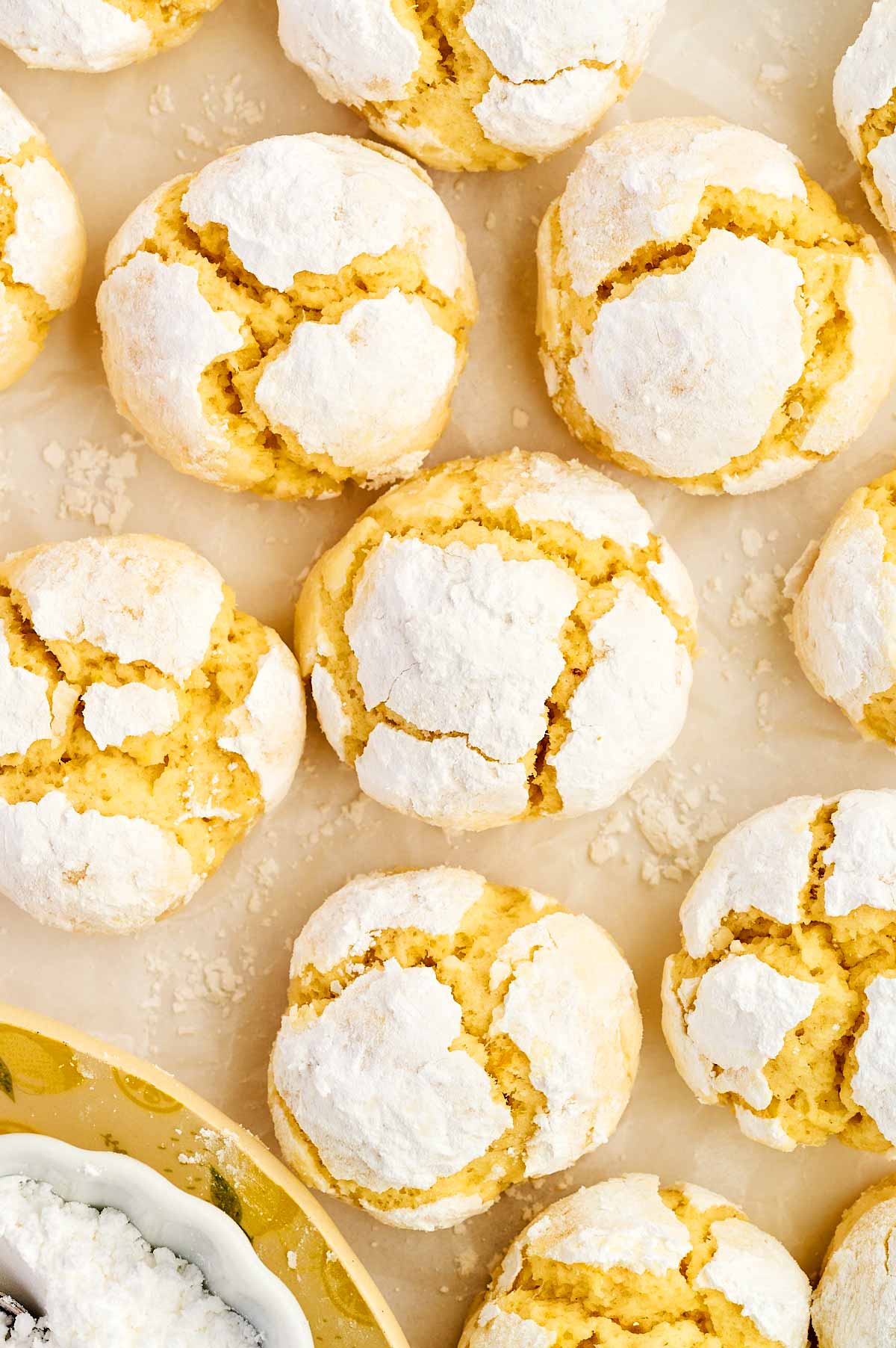 Lemon crinkle cookies on parchment paper.