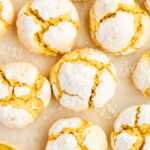 Lemon crinkle cookies on parchment paper.