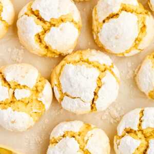 Lemon crinkle cookies on parchment paper.