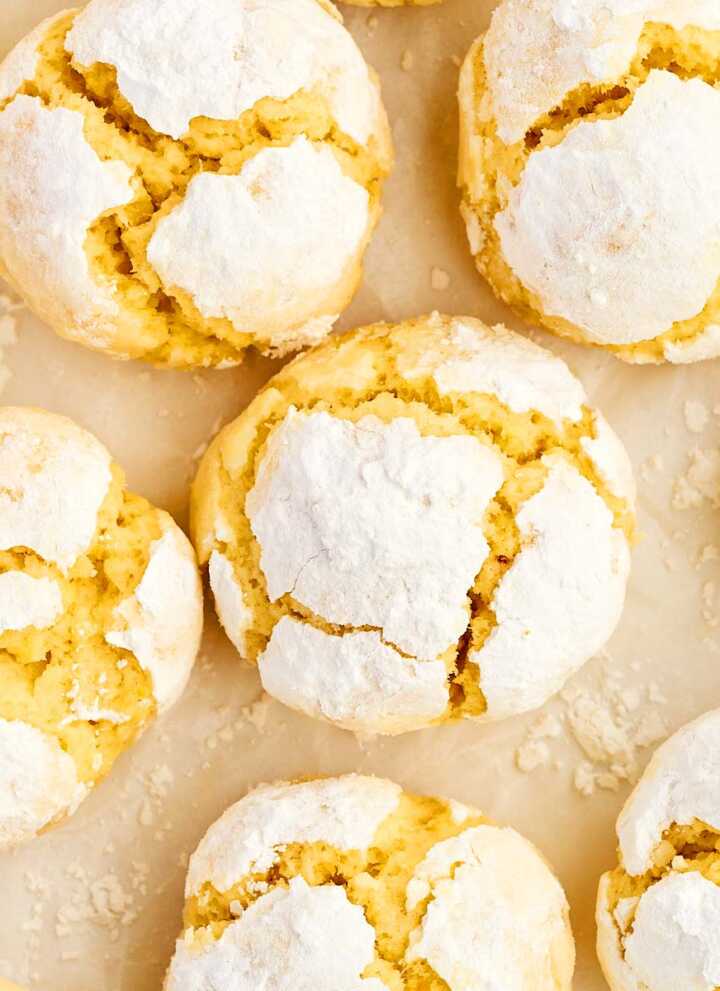 Lemon crinkle cookies on parchment paper.