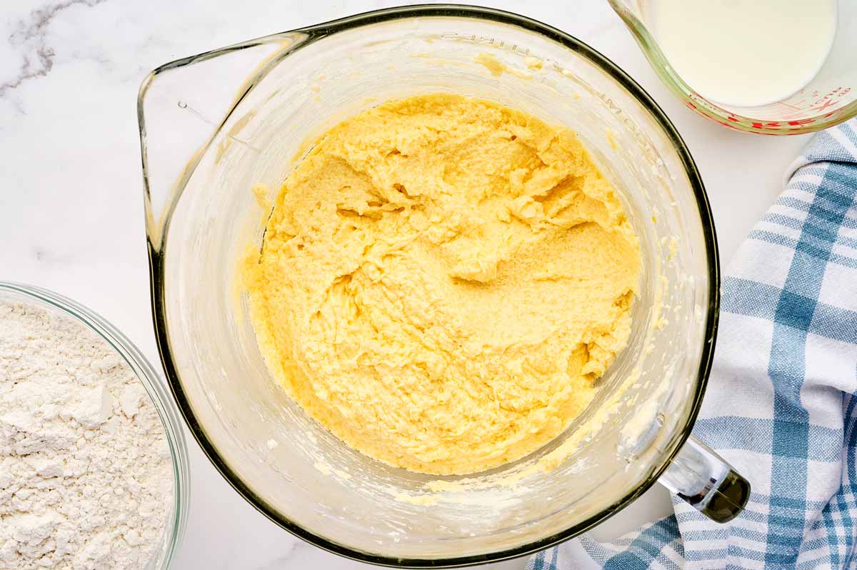 Creamed butter and sugar and eggs in a glass bowl.
