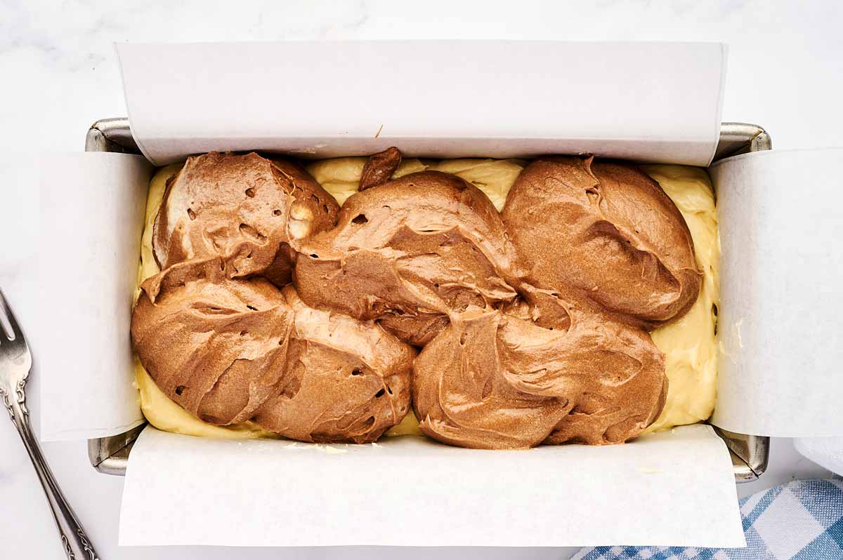 Chocolate and vanilla batter in loaf pan.