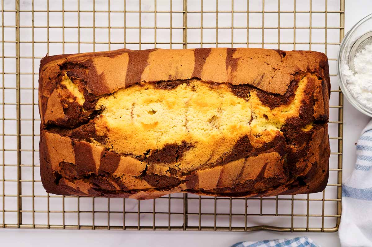 Marble loaf cake cooling on a wire rack.