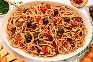 Serving pasta puttanesca on a platter.