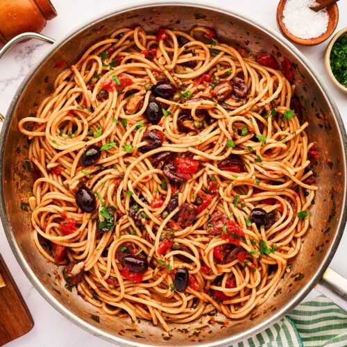 Skillet with pasta puttanesca.