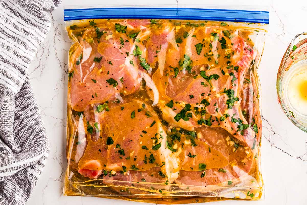 Pork chops in zip top bag with marinade.