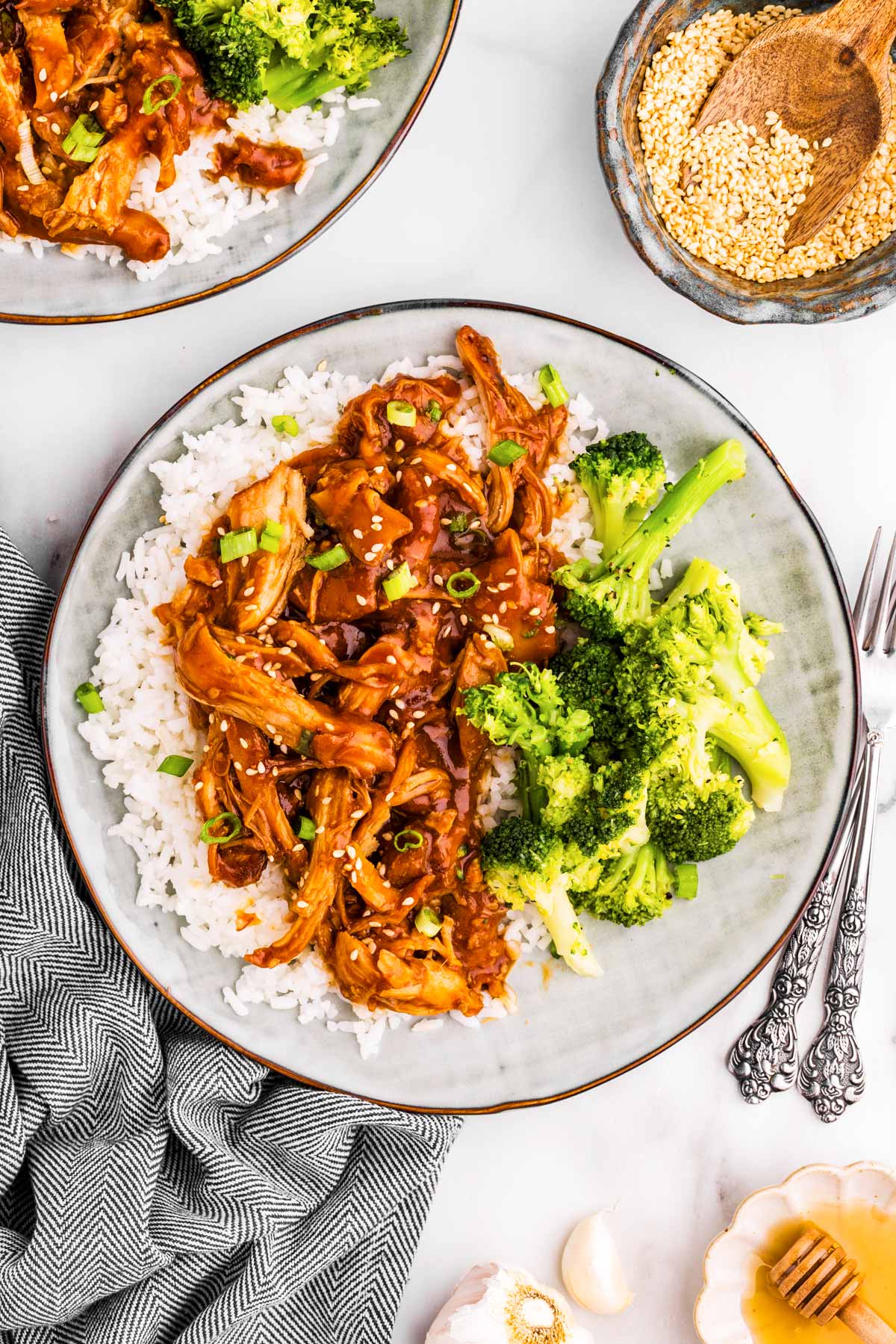 Plate with honey garlic chicken, rice and broccoli.