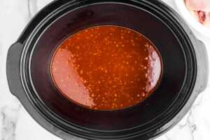 Honey garlic sauce in slow cooker insert.