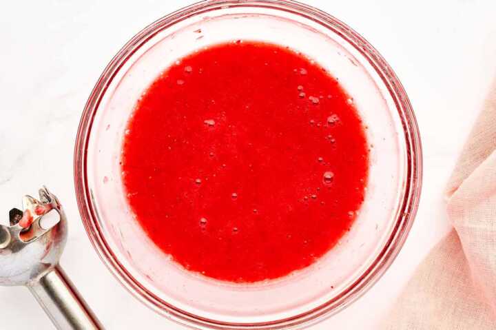 Strawberry purée in a glass bowl.