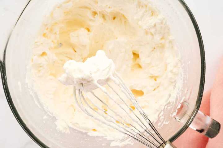 Whipped cream on whisk attachment.