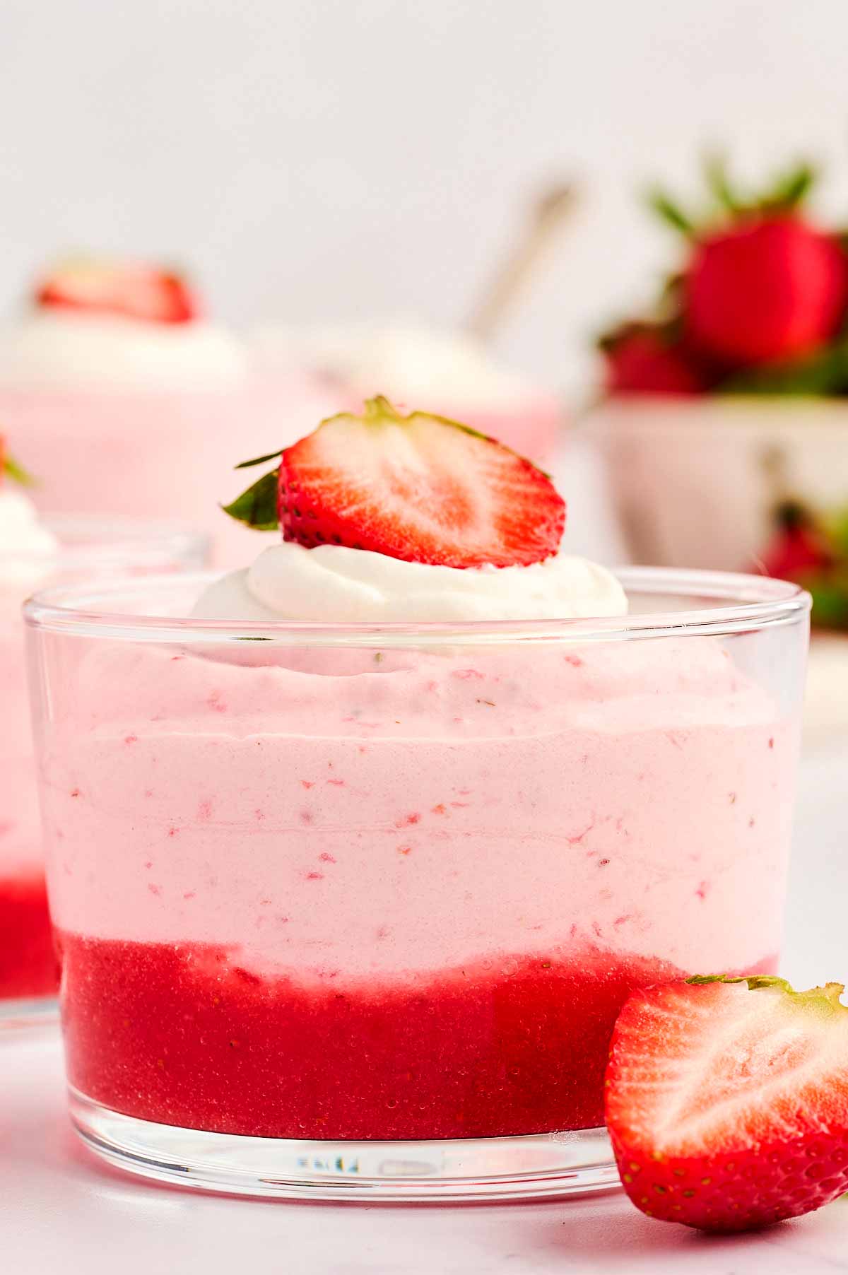 Close up shot of a glass cup with strawberry mousse.