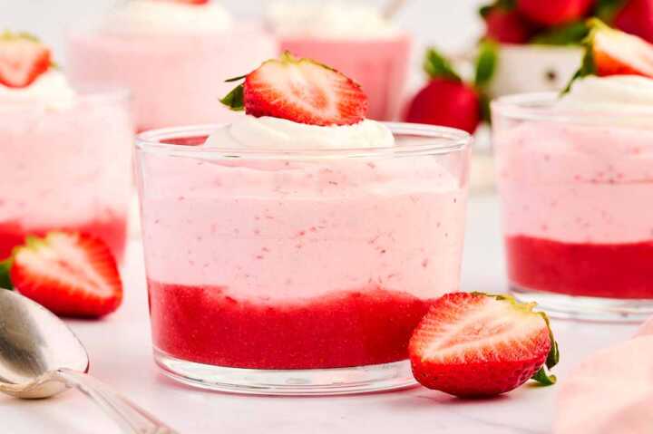 Strawberry mousse in glass cup with strawberry purée.