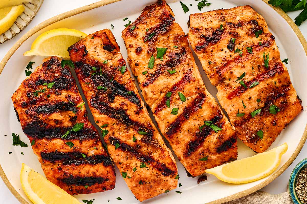 Grilled salmon fillets on a platter.