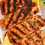 Grilled salmon fillets on a platter.