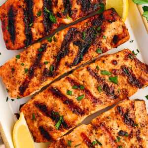 Grilled salmon fillets on a platter.