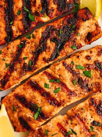 Grilled salmon fillets on a platter.