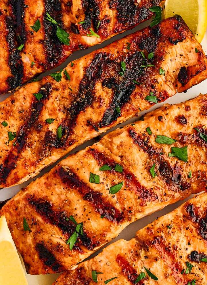 Grilled salmon fillets on a platter.