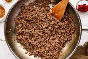 Browning ground beef in a skillet.