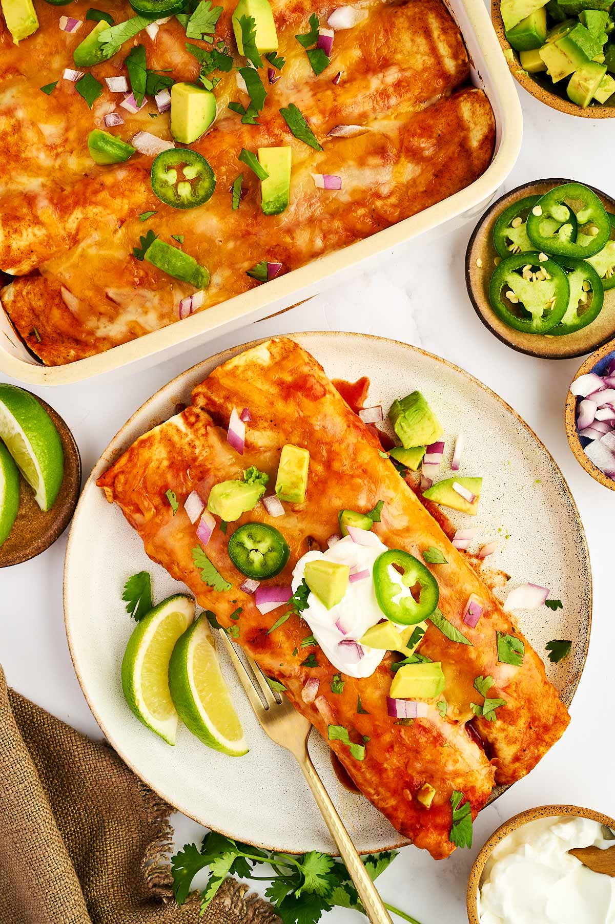 Ground beef enchiladas being plated.