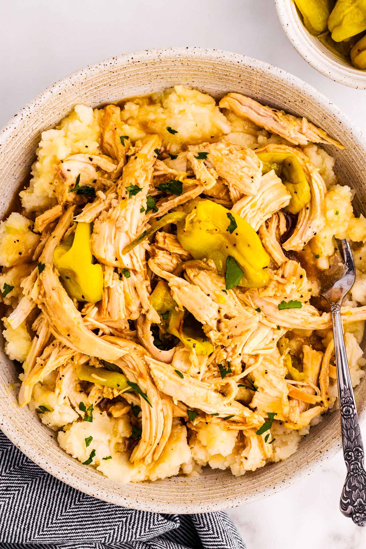Bowl with Mississippi Chicken served over mashed potatoes.
