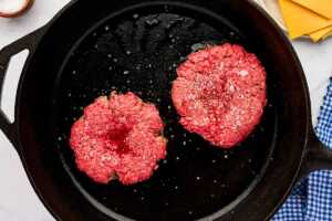 Searing burger patties.