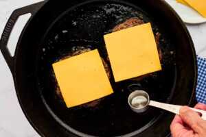 Burger patties topped with cheese.
