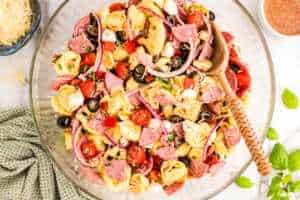 Serving Tortellini Pasta Salad in a glass bowl.