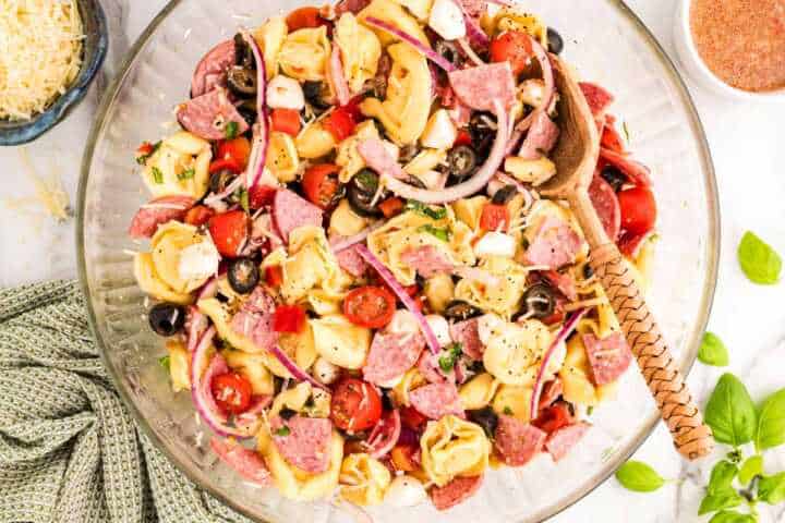 Serving Tortellini Pasta Salad in a glass bowl.