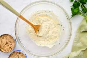 Tuna salad sauce in a glass bowl.