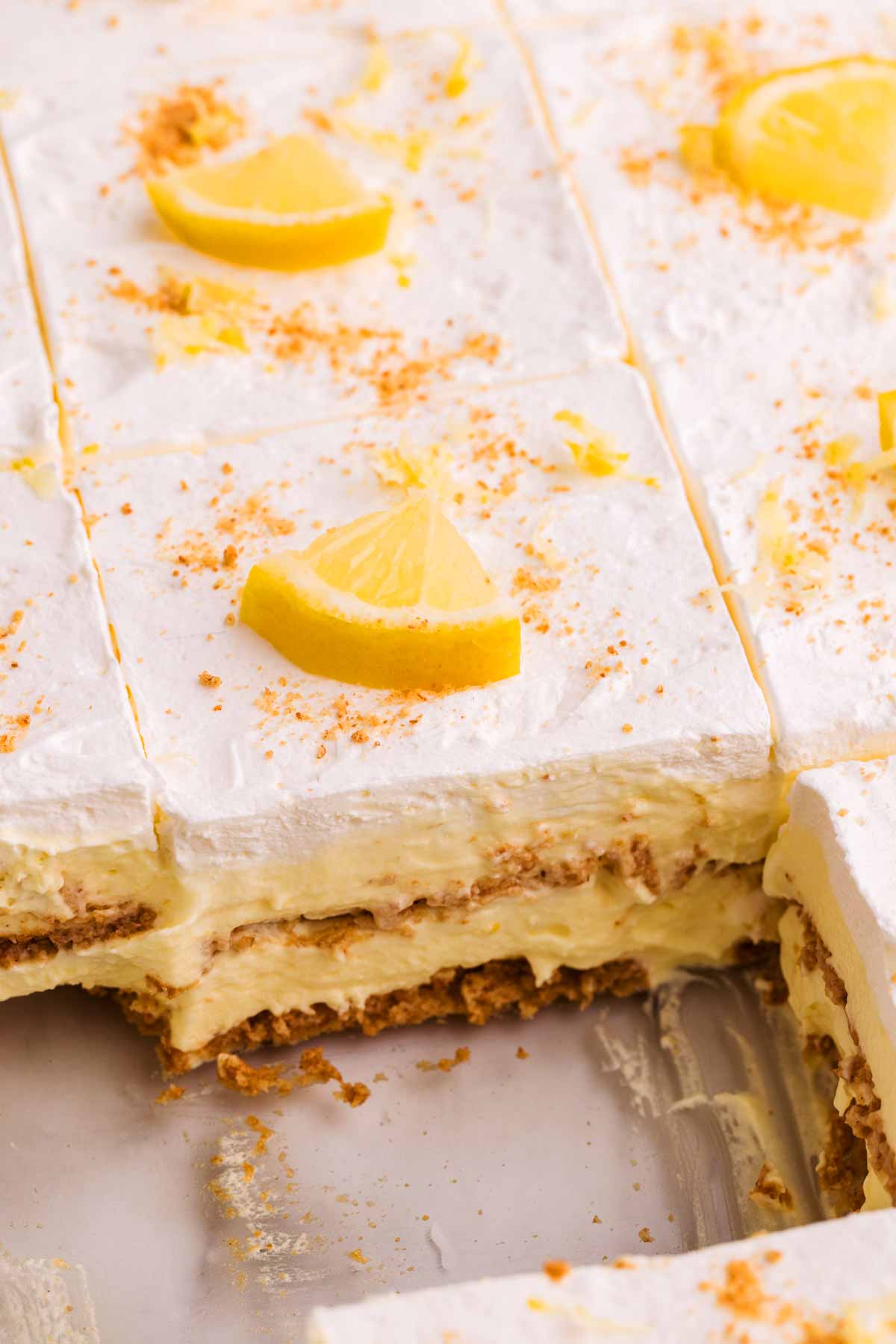 Frontal view of lemon icebox cake in a glass pan.