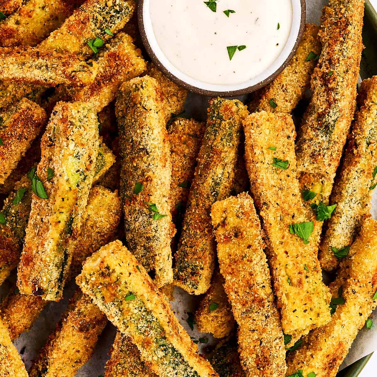 Baked Parmesan Zucchini Fries on a platter with ranch dip.