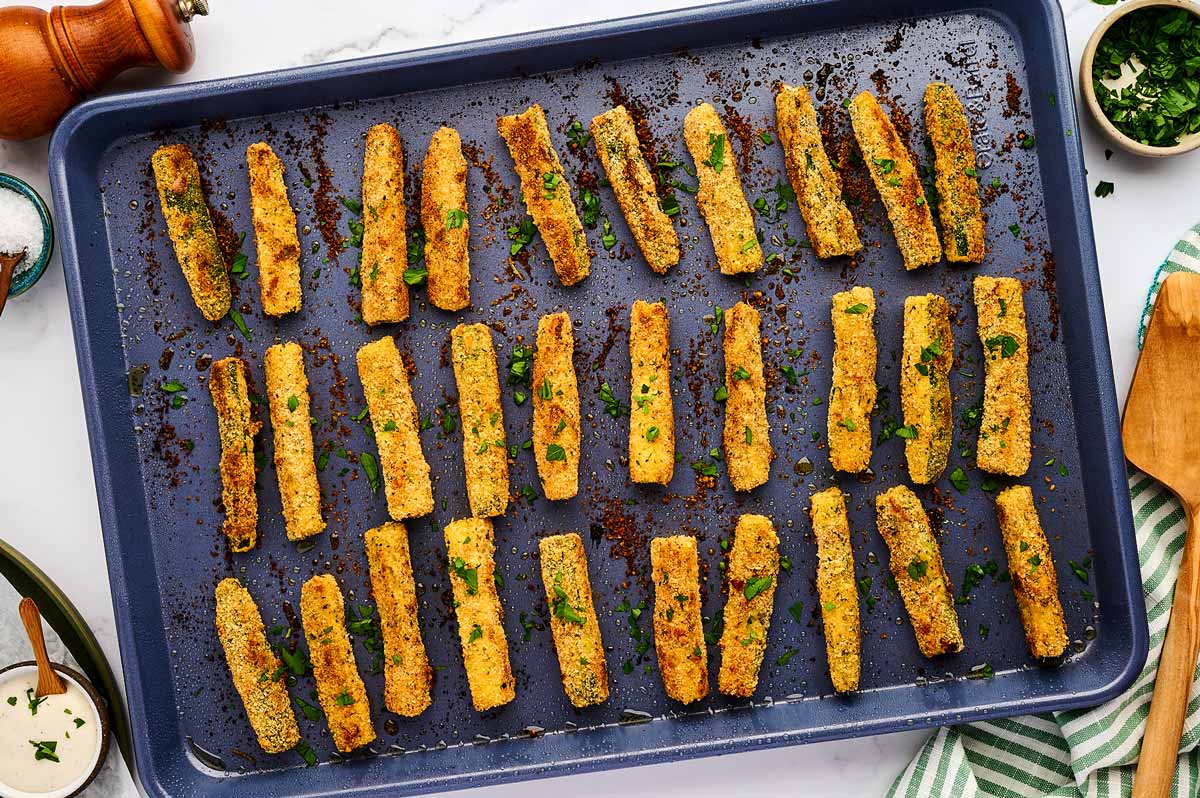 Baked zucchini fries on a sheet pan.