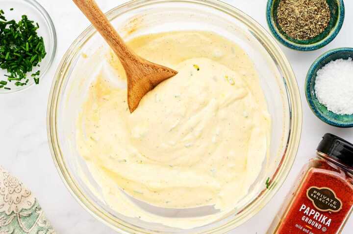 Creamy dressing for potato salad in a glass bowl.
