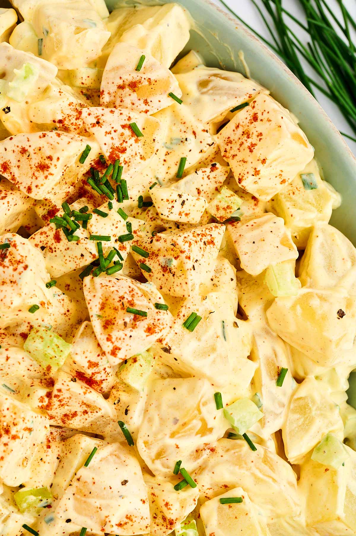 Close up photo of creamy potato salad in a bowl.