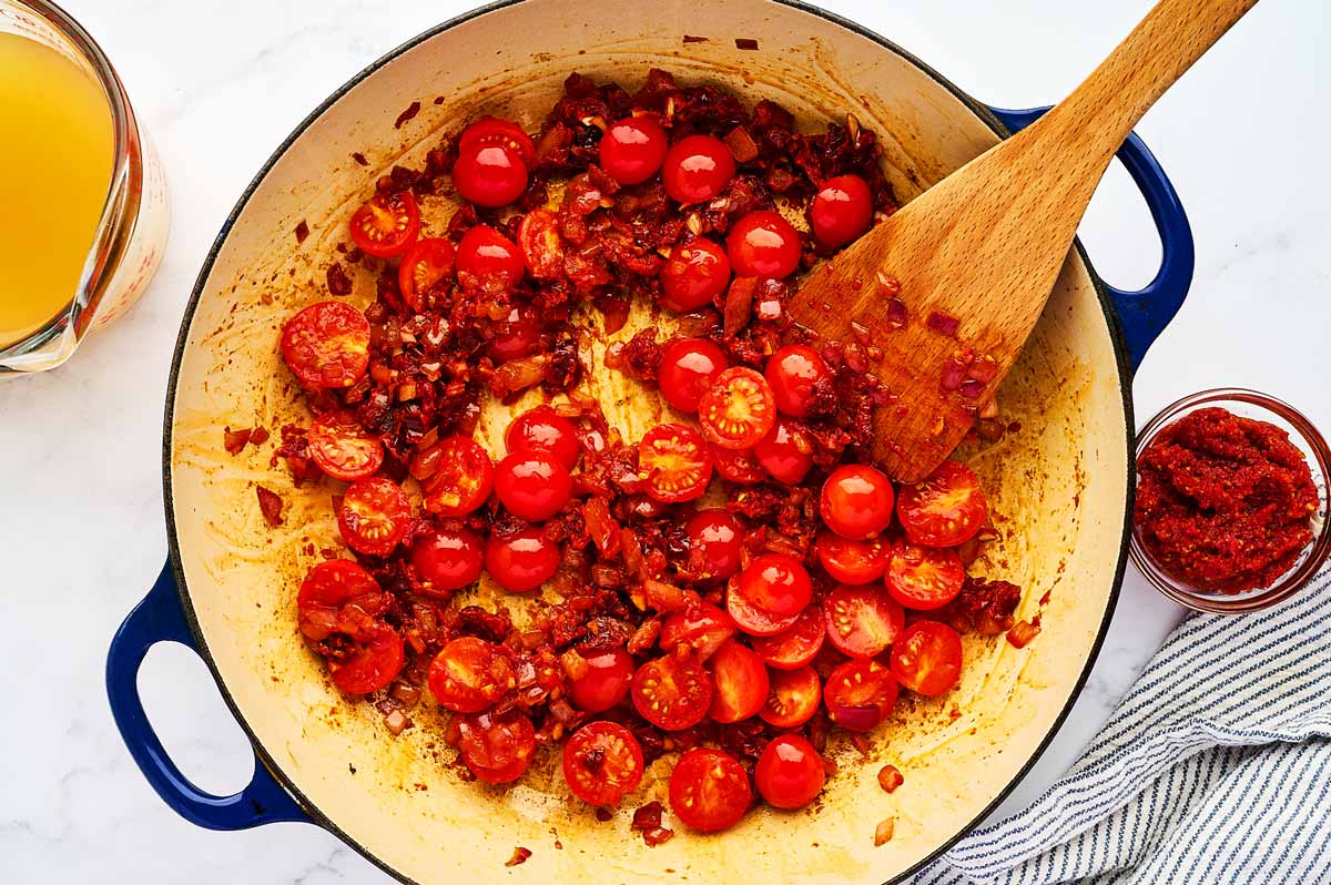 Sautéing tomatoes in the skillet.