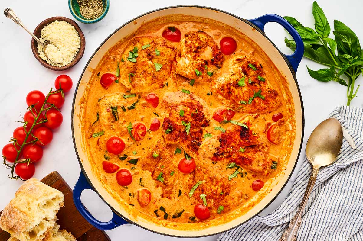 Serving creamy tomato basil chicken from a skillet.