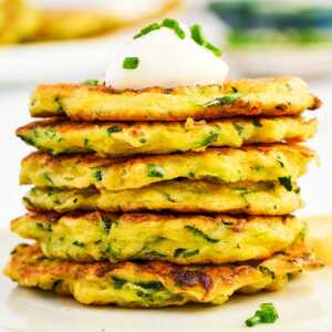 Stack of zucchini fritters on a plate.