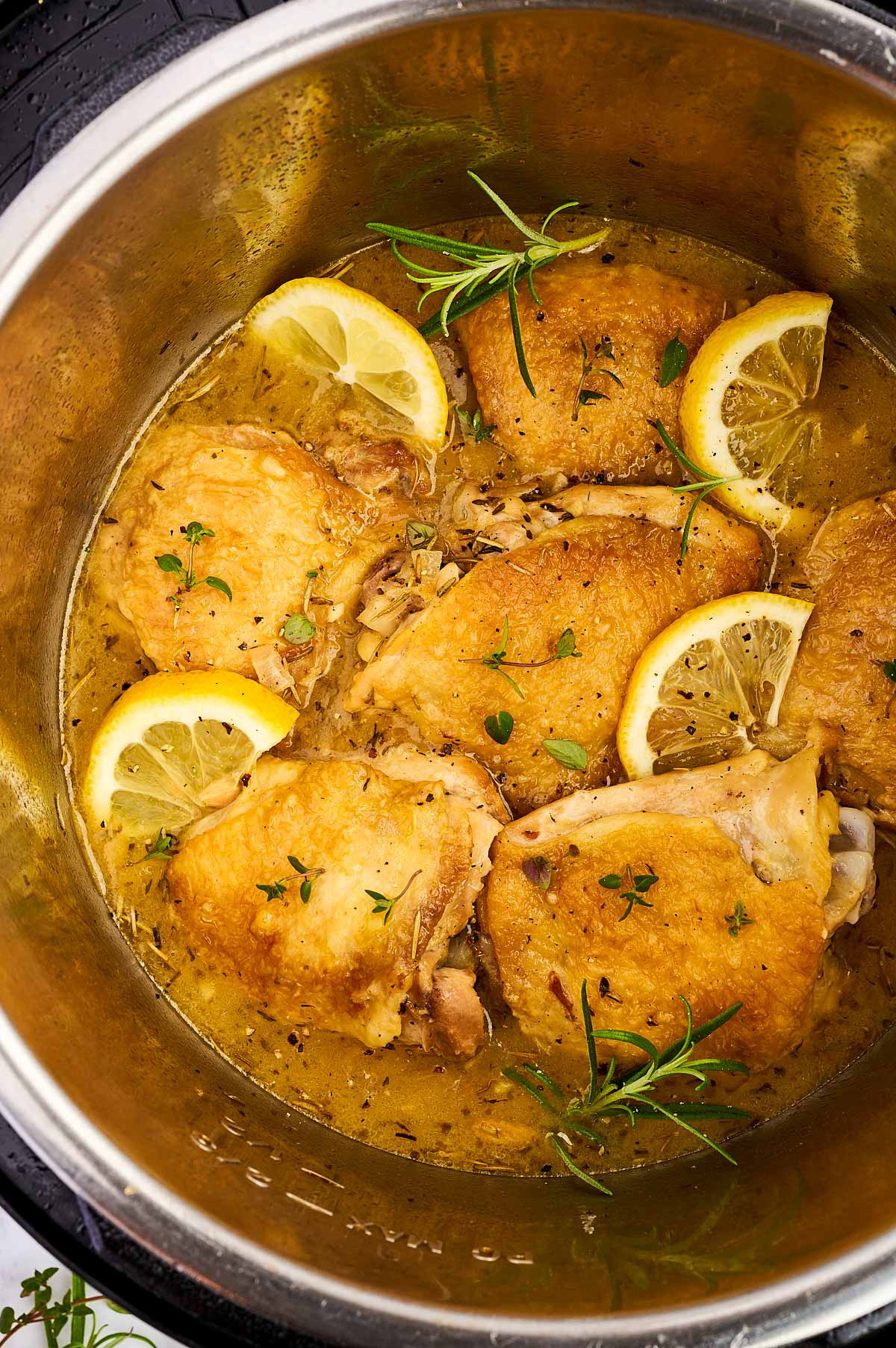 Overhead close up view of lemon chicken thighs in an instant pot.