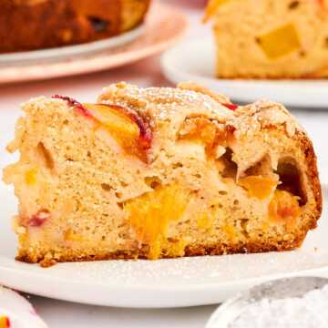 Slice of peach cake on a plate.