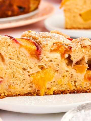 Slice of peach cake on a plate.