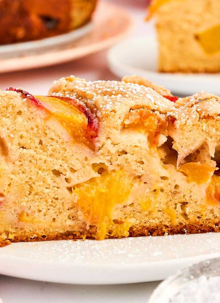 Slice of peach cake on a plate.