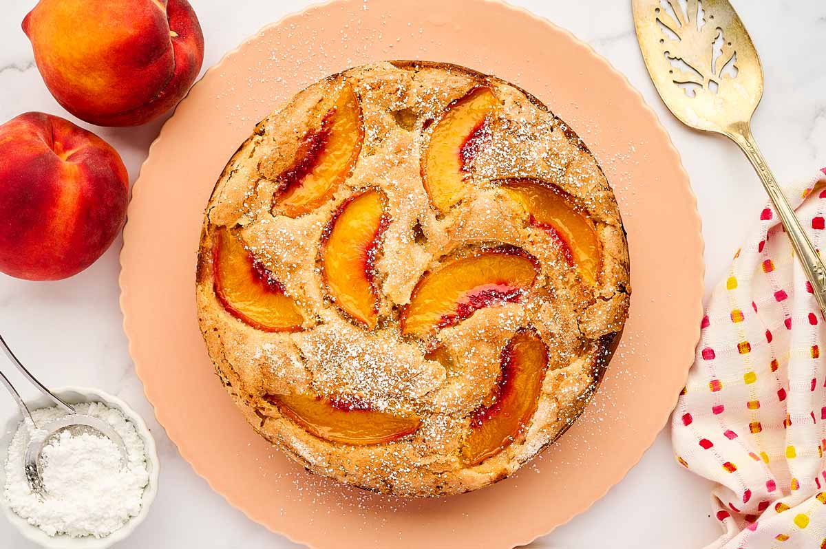 Peach cake on a cake platter.