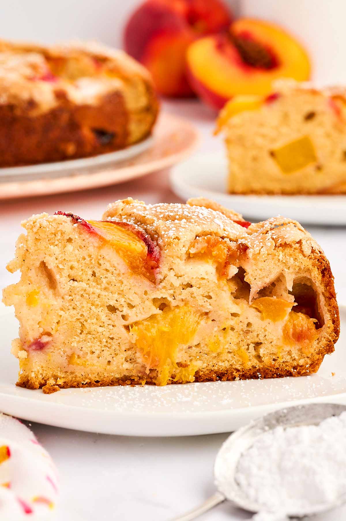 Slice of peach cake on a plate.