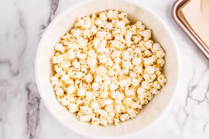 Popped popcorn in a white bowl.