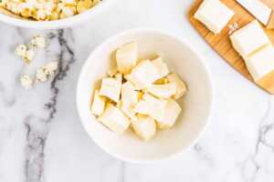 Melting vanilla almond bark in a bowl.