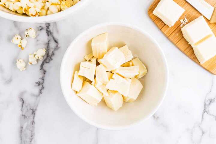 Melting vanilla almond bark in a bowl.