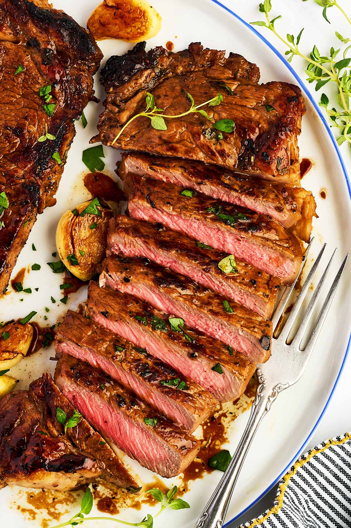 Sliced steak on a white plate.